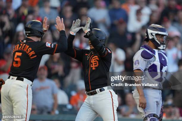 Thairo Estrada of the San Francisco Giants celebrates with Mike Yastrzemski of the San Francisco Giants after hitting a home run against the Colorado...