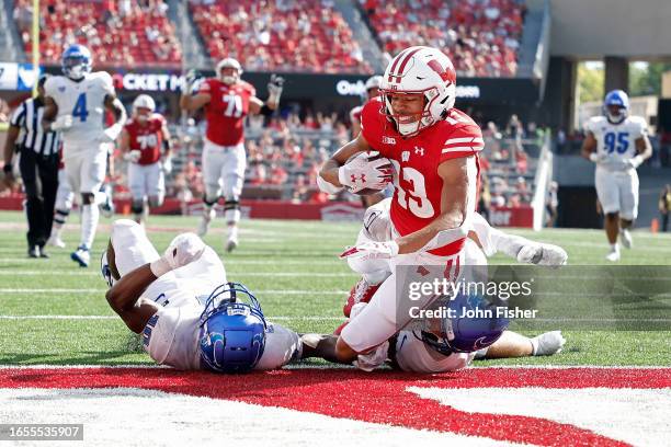 Chimere Dike of the Wisconsin Badgers scores on a 29 yard touchdown pass in the second quarter against the Buffalo Bulls at Camp Randall Stadium on...