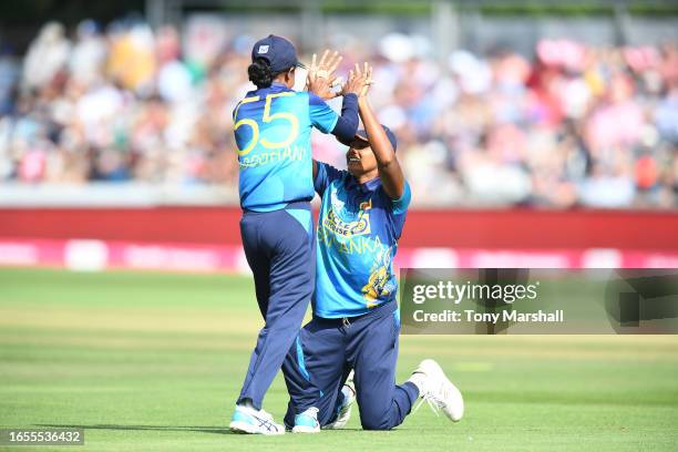 Inoka Ranaweera of Sri Lanka Women celebrates with team mate Udeshika Prabodhani after catching out Dannielle Gibson of England Women during the 2nd...