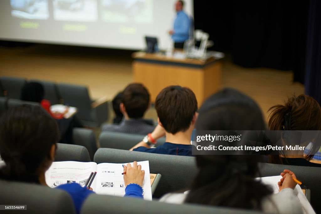Students reading book in class