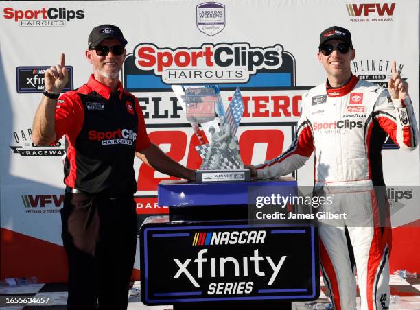 Denny Hamlin, driver of the Sport Clips Haircuts Toyota, and crew chief Jason Ratcliff celebrate in victory lane after winning the NASCAR Xfinity...