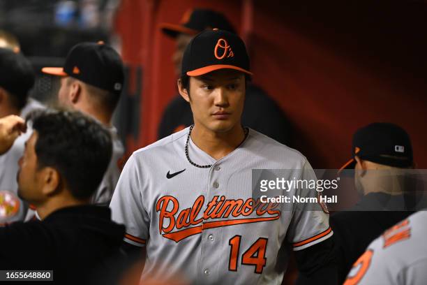 Shintaro Fujinami of the Baltimore Orioles walks through the dugout after the end of the eighth inning against the Arizona Diamondbacks at Chase...