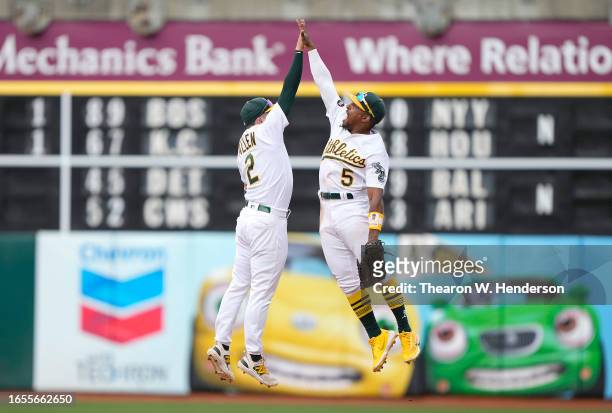 Nick Allen and Tony Kemp of the Oakland Athletics celebrate defeating the Los Angeles Angels 2-1 at RingCentral Coliseum on September 02, 2023 in...