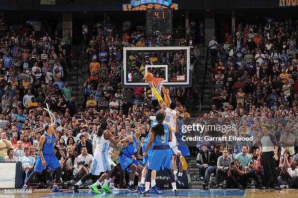 Andre Iguodala of the Denver Nuggets makes a go-ahead layup late in the fourth quarter against Vince Carter of the Dallas Mavericks, leading to his...