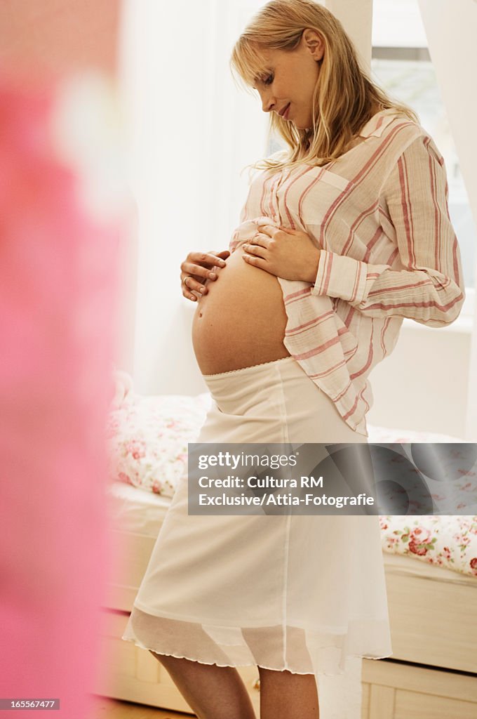 Pregnant woman rubbing belly