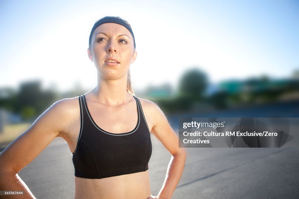 Runner standing on city street