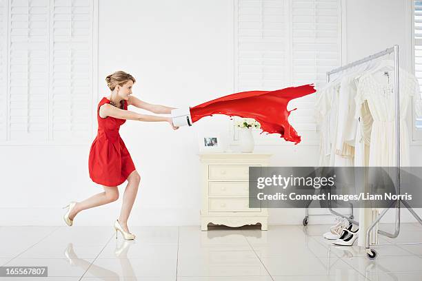 woman throwing red paint on clothes - stubborn stock pictures, royalty-free photos & images