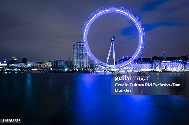 blurred view of london eye at night - ロンドン・アイ ストックフォトと画像