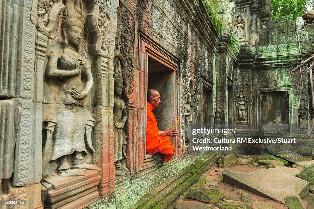 Buddhist monk in ornate temple