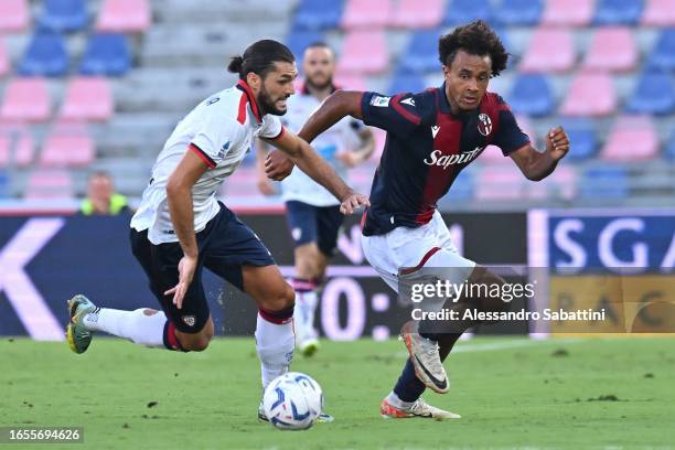 Alberto Dossena of Cagliari Calcio competes for the ball with Joshua Zirkzee of Bologna FC during the Serie A TIM match between Bologna FC and...