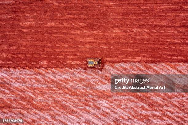 bulldozer working in an aluminium mine photographed from directly above, queensland, australia - geology technology stock pictures, royalty-free photos & images