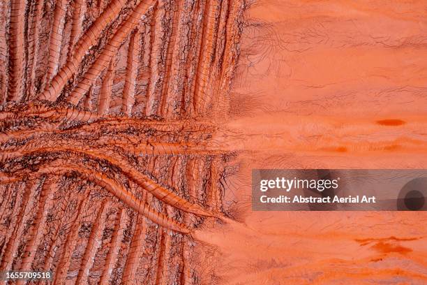 tire tracks in the tailing pond of an aluminium mine shot from a drone perspective, queensland, australia - mining from above ストックフォトと画像