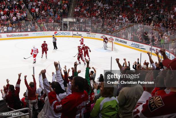 Fans cheer after Martin Hanzal of the Phoenix Coyotes scored a empty net goal against the Detroit Red Wings during the final moments of the NHL game...