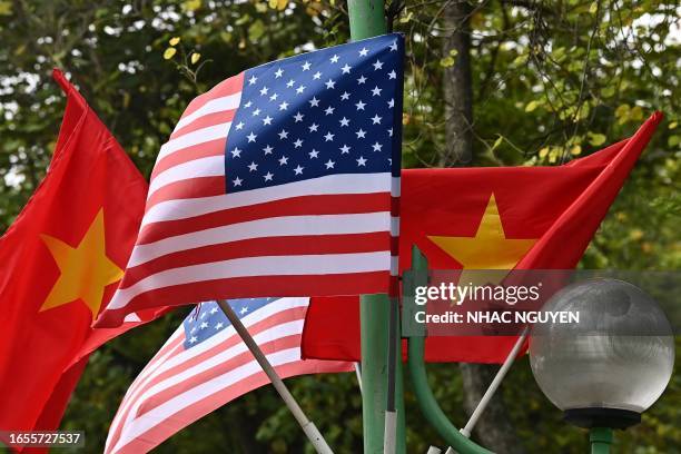 And Vietnam national flags fly on a street light in Hanoi on September 10 ahead of US President Joe Biden's visit to Vietnam.