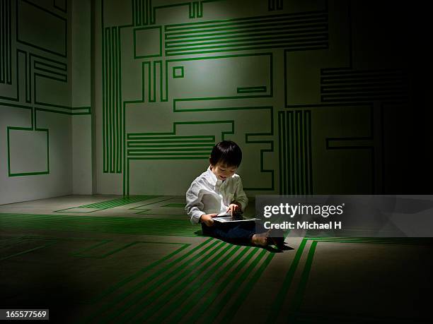 boy using digital tablet in the circuit board room - michael virtue stock pictures, royalty-free photos & images
