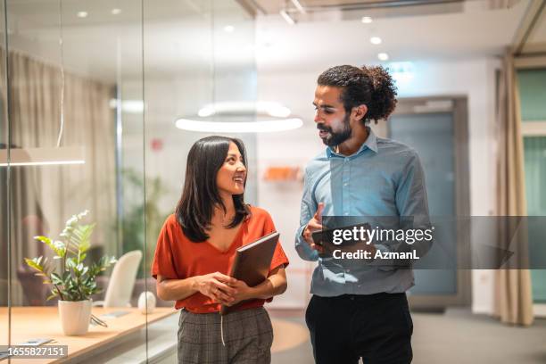 young multicultural colleagues utilizing digital technology - büro stock pictures, royalty-free photos & images