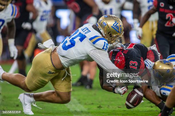 Defensive lineman Laiatu Latu forces a fumble from San Diego State running back Martin Blake at the goal line to prevent a touchdown, in the second...