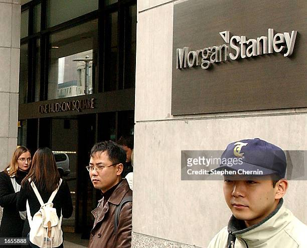 People stand outside the Morgan Stanley offices in downtown Manhattan November 22, 2002 in New York City. The investment bank has announced it is...