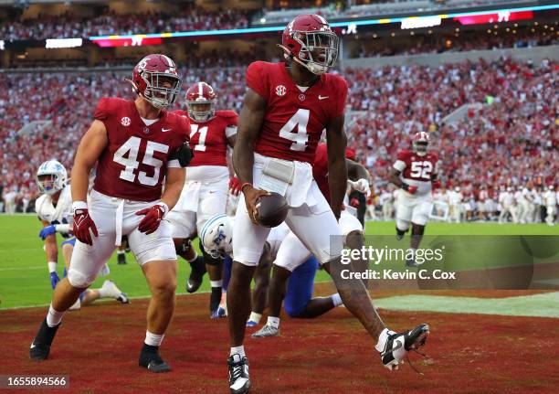 Jalen Milroe of the Alabama Crimson Tide reacts after rushing for a touchdown against the Middle Tennessee Blue Raiders during the first quarter at...