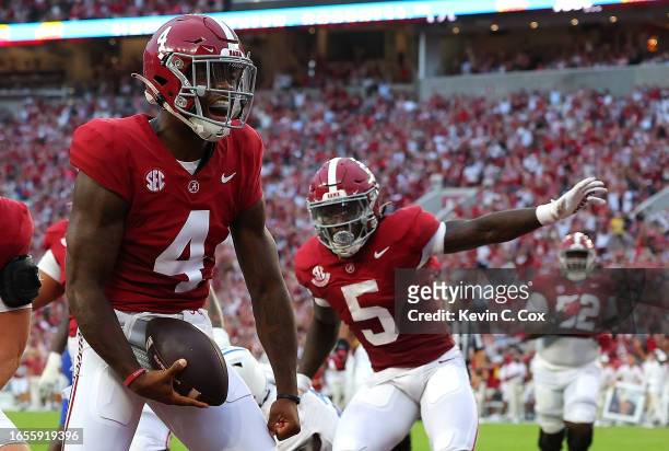 Jalen Milroe of the Alabama Crimson Tide reacts after rushing for a touchdown against the Middle Tennessee Blue Raiders during the first quarter at...