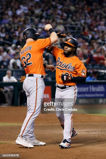 Cedric Mullins of the Baltimore Orioles reacts with Ryan O'Hearn after hitting a three-run home run during the fourth inning against the Arizona...