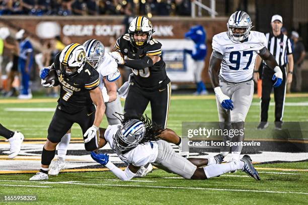 Missouri Tigers running back Cody Schrader gets brought down but the ankle by Middle Tennessee Blue Raiders cornerback Deonte Stanley but manages to...