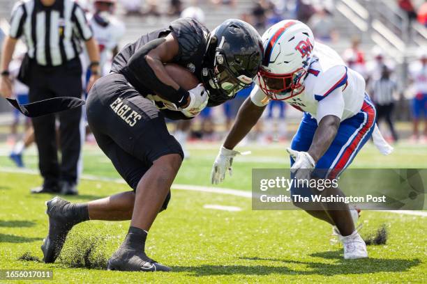 Freedom running back Jeffrey Overton carries past DeMatha safety Dhonte Jackson during a high school football game on Saturday, September 9, 2023....