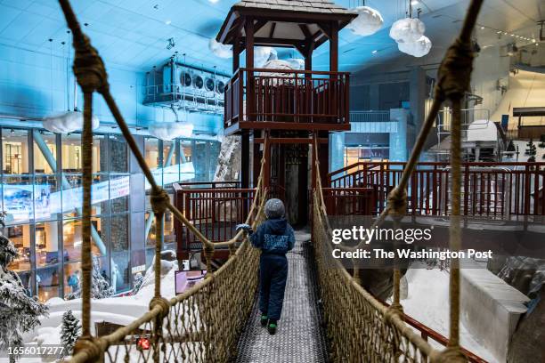 Child walks across a rope bridge at Ski Dubai on August 1, 2023 in Dubai, United Arab Emirates. In the UAE's hot, humid summer months, temperatures...