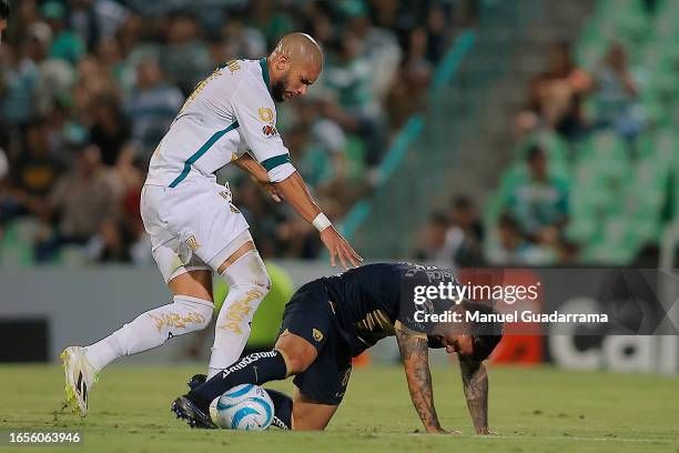 Matheus Doria of Santos struggles for the ball with Christian Tabo of Pumas during the 7th round match between Santos Laguna and Pumas UNAM as part...