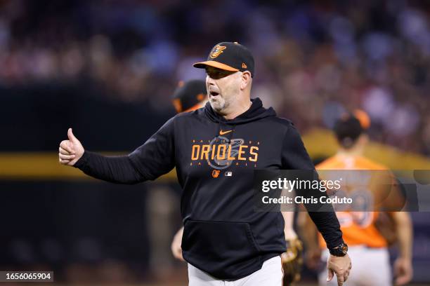 Manager Brandon Hyde of the Baltimore Orioles gestures after a pitching change during the eighth inning against the Arizona Diamondbacks at Chase...