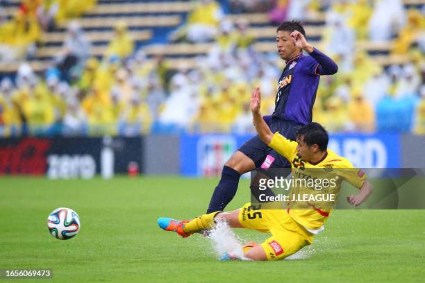 Kazuyuki Morisaki of Sanfrecce Hiroshima is tackled by Yusuke Kobayashi of Kashiwa Reysol during the J.League J1 match between Kashiwa Reysol and...