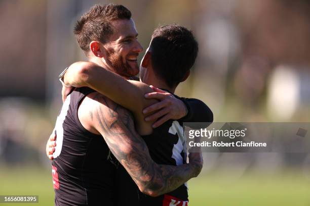 Nick Daicos of the Magpies is embraced by Jeremy Howe during a Collingwood Magpies training and media session at AIA Vitality Centre on September 03,...