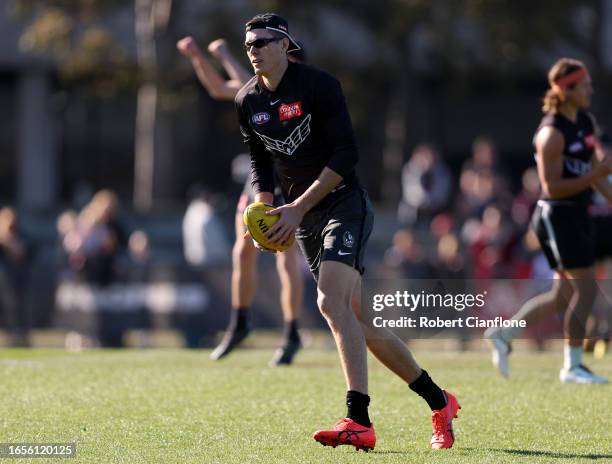 Mason Cox of the Magpies runs with the ball during a Collingwood Magpies training and media session at AIA Vitality Centre on September 03, 2023 in...