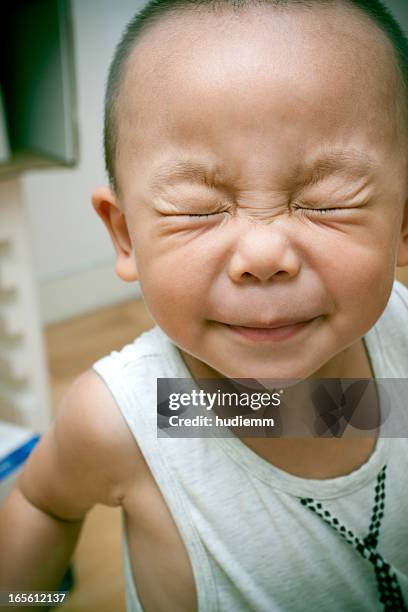 asian child with eyes closed (xxl) - funny baby faces stock pictures, royalty-free photos & images