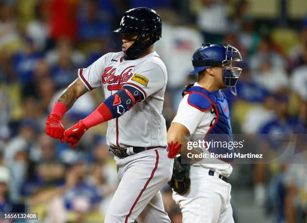 Orlando Arcia of the Atlanta Braves celebrates hitting a three-run home run against the Los Angeles Dodgers in the tenth inning at Dodger Stadium on...