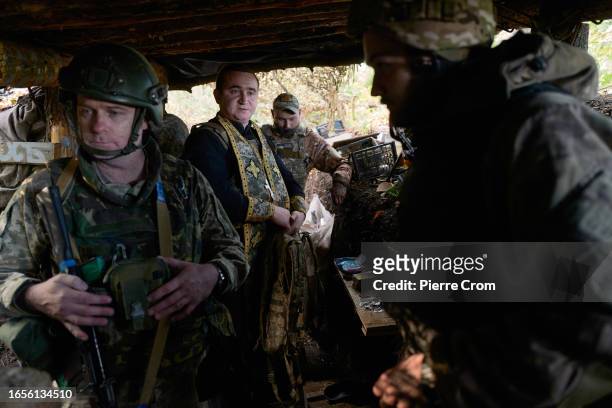 Ukrainian military chaplain Ivan prays with infantry soldiers of the "Black Zaporozhian Cossacks" 72th Brigade on the frontline near Donetsk on...