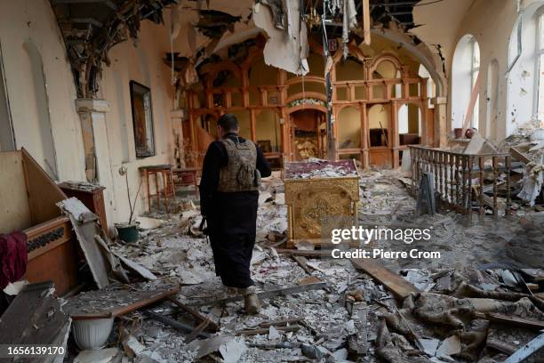 Ukrainian military chaplain Ivan visits a bombed church with an infantry soldier of the "Black Zaporozhian Cossacks" 72th Brigade on the frontline...