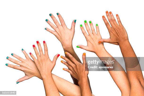 group of raised multiethnics female hands with colored manicure - nail polish stock pictures, royalty-free photos & images