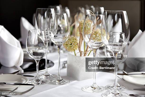 restaurant table with wine glasses and napkins - fancy restaurant stock pictures, royalty-free photos & images