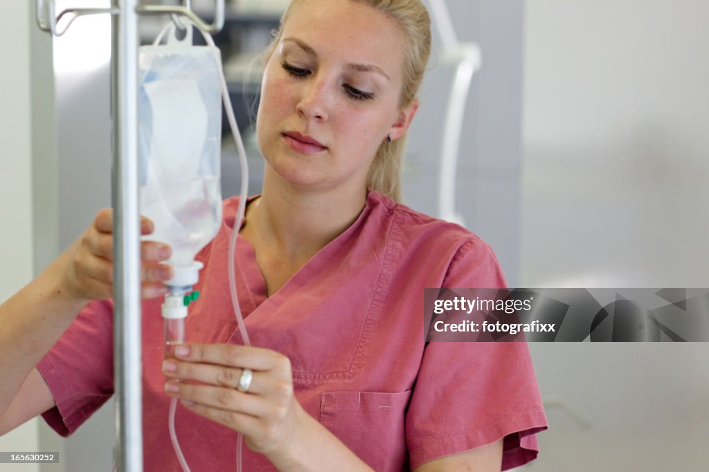 A female nurse preparing an infusion