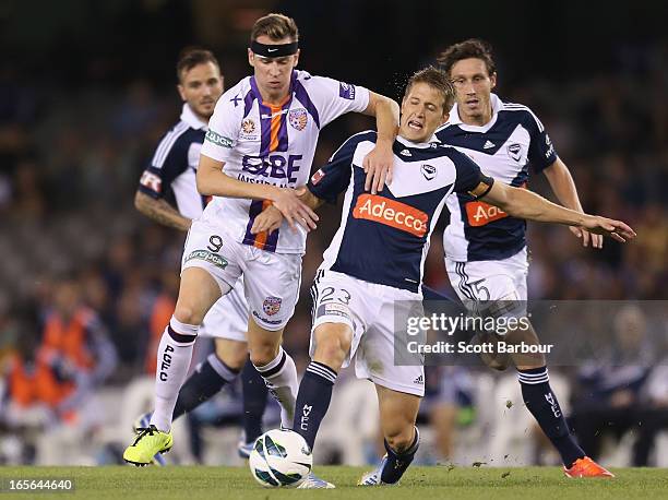 Adrian Leijer of the Victory and Shane Smeltz of the Glory compete for the ball during the A-League Elimination final match between the Melbourne...