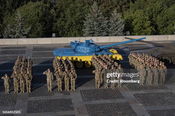 Cadets of the military institute Taras Shevchenko National University of Kyiv next to a tank painted in the colours of the Ukraine national flag,...