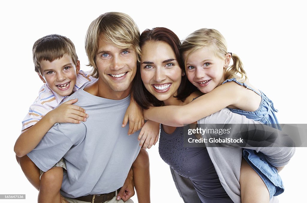 Kids enjoying piggy back rides on parents