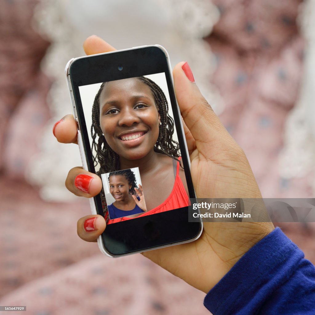 Girl friends connecting using Skype on a phone.