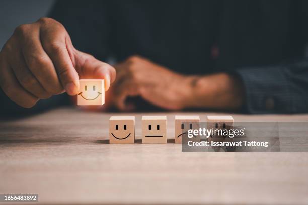 customer service and satisfaction concept ,business people are touching the virtual screen on the happy smiley face icon to give satisfaction in service. rating very impressed - smiley face stock pictures, royalty-free photos & images