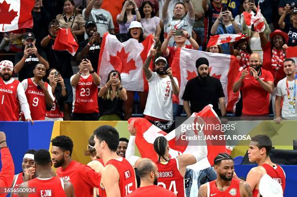 Canada's fans celebrate their victory at the FIBA Basketball World Cup game for third place between USA and Canada in Manila on September 10, 2023.