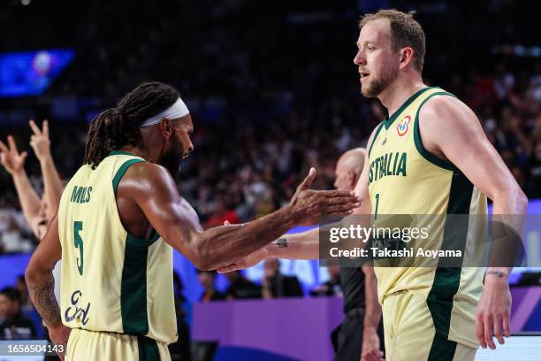 Patty Mills of Australia celebrates a three point basket with Joe Ingles during the FIBA Basketball World Cup 2nd Round Group K game between...