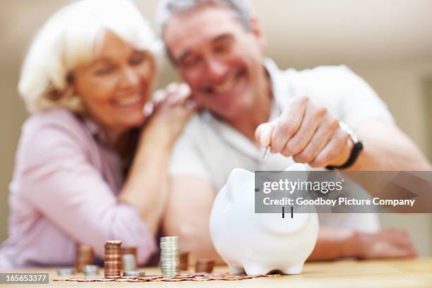 save money - couple saving piggy bank stock pictures, royalty-free photos & images