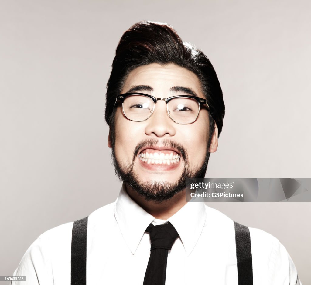 Asian business man with a goofy smile on his face