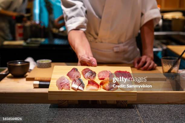 close up slice of sashimi on the wooden board - sashimi stock pictures, royalty-free photos & images